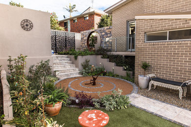 Design ideas for a large courtyard full sun garden in Sydney with decking.