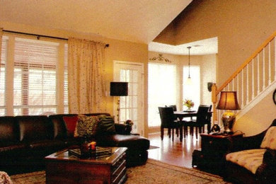 Inspiration for a mid-sized timeless open concept medium tone wood floor family room remodel in Austin with beige walls, a standard fireplace, a tile fireplace and a wall-mounted tv