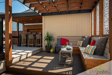 Example of a trendy backyard patio design in Montreal with decking