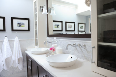 Mid-sized transitional master gray tile and stone slab marble floor walk-in shower photo in Vancouver with shaker cabinets, dark wood cabinets, a one-piece toilet, gray walls, a vessel sink and quartz countertops