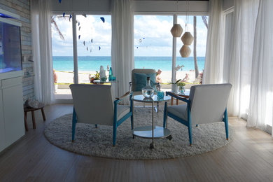 Living room - mid-sized coastal formal and open concept light wood floor living room idea in Miami with white walls, no fireplace and no tv