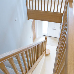 Design ideas for a modern carpeted straight staircase in Hertfordshire with carpeted risers.
