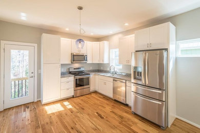 Inspiration for a mid-sized modern light wood floor kitchen remodel in Other