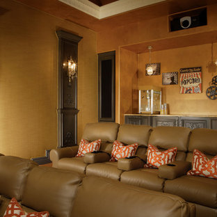 Design ideas for an expansive traditional enclosed home cinema in Phoenix with orange walls, carpet and a projector screen.