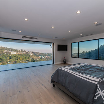 Bedroom with Built-In Wardrobe Wall and Panoramic Glazing