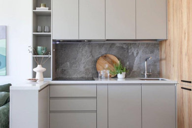 Example of a small trendy l-shaped gray floor kitchen design in Moscow with a single-bowl sink, flat-panel cabinets, gray cabinets, gray backsplash and white countertops