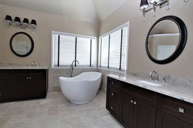 Bathroom - mid-sized modern master beige tile and stone tile marble floor and beige floor bathroom idea in Atlanta with brown cabinets, a two-piece toilet, beige walls, an undermount sink, granite countertops, a hinged shower door and beige countertops