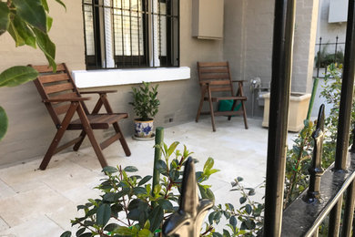 Inspiration for a small timeless stone patio remodel in Sydney