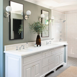 Example of a transitional master white tile gray floor bathroom design in San Francisco with raised-panel cabinets, white cabinets, an undermount sink and white countertops