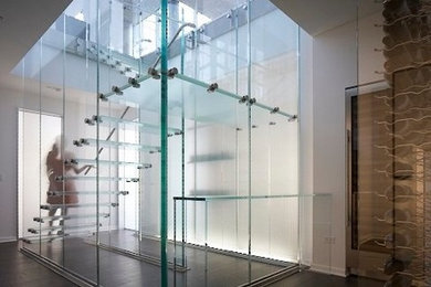 Inspiration for a modern glass floating staircase in Chicago with open risers.