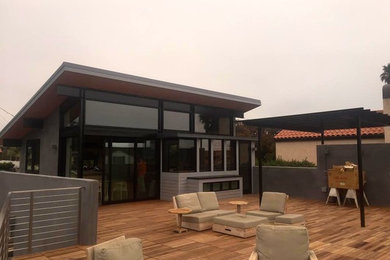 Example of a large trendy rooftop deck design in San Francisco with a pergola