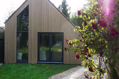 This is an example of a medium sized modern back full sun garden for summer in Other.