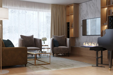 Modelo de salón abierto moderno pequeño con paredes beige, suelo de madera clara, chimeneas suspendidas, marco de chimenea de hormigón y pared multimedia