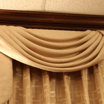 Swags overlaying pinch pleated curtains