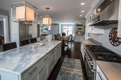 Eat-in kitchen - coastal u-shaped dark wood floor eat-in kitchen idea in New York with beaded inset cabinets, white cabinets, quartzite countertops and stainless steel appliances