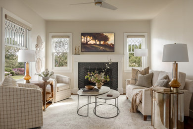 Example of a mid-sized transitional dark wood floor, brown floor, tray ceiling and wainscoting living room design in Seattle with white walls, a standard fireplace, a tile fireplace and a wall-mounted tv