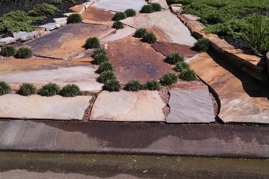 Inspiration for a mid-sized traditional front yard stone landscaping in Houston.