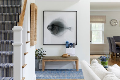 Inspiration for a large coastal medium tone wood floor single front door remodel in New York with white walls and a white front door