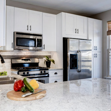 White Kitchen Remodel with Colonial White Granite and Stainless Steel Appliances