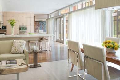 Huge transitional medium tone wood floor eat-in kitchen photo in DC Metro with flat-panel cabinets, light wood cabinets, marble countertops, white backsplash, stainless steel appliances and an island