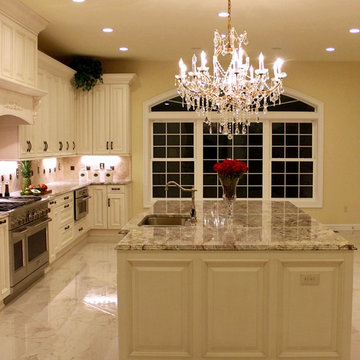 Luxurious Kitchen w/Antique White Cabinetry & Sienna Bordeaux Granite Countertop