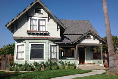 Inspiration for a mid-sized victorian green two-story wood and clapboard gable roof remodel in Orange County with a shingle roof and a gray roof