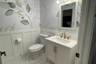 Inspiration for a small transitional marble floor and wallpaper powder room remodel in Denver with white cabinets, white countertops, a freestanding vanity, furniture-like cabinets and quartz countertops
