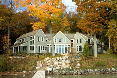 Large arts and crafts gray two-story wood exterior home photo in Other with a shingle roof