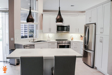 Kitchen - mid-sized contemporary kitchen idea in Miami with a single-bowl sink, shaker cabinets, white cabinets, glass tile backsplash and white countertops