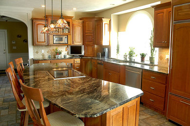 Mid-sized elegant u-shaped ceramic tile open concept kitchen photo in Boston with a drop-in sink, raised-panel cabinets, medium tone wood cabinets, granite countertops and an island