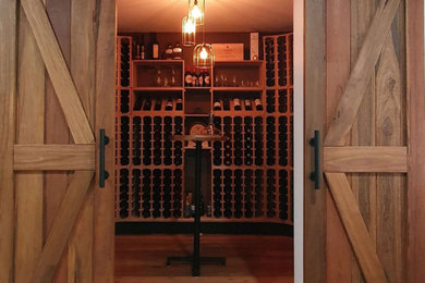 Wine cellar - industrial wine cellar idea in New York