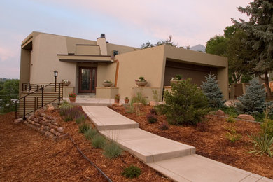 Small contemporary two-storey stucco beige exterior in Denver with a flat roof.