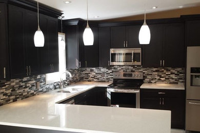 Inspiration for a contemporary ceramic tile and beige floor kitchen remodel in DC Metro with an undermount sink, recessed-panel cabinets, dark wood cabinets, quartz countertops, multicolored backsplash, ceramic backsplash and stainless steel appliances