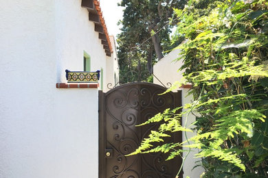Inspiration for a mid-sized mediterranean single front door remodel with white walls and a black front door