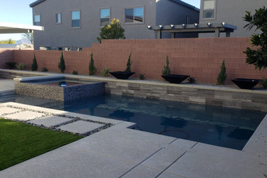 Inspiration for a small modern backyard rectangular pool remodel in Las Vegas with decking
