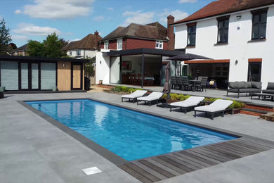 Medium sized contemporary back swimming pool in Kent.