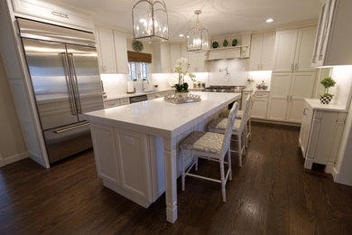 Inspiration for a large timeless medium tone wood floor eat-in kitchen remodel in St Louis with recessed-panel cabinets, white cabinets, marble countertops, white backsplash, marble backsplash, an island and white countertops