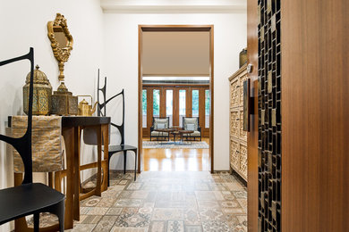 Tuscan carpeted and multicolored floor entry hall photo in Bengaluru with white walls
