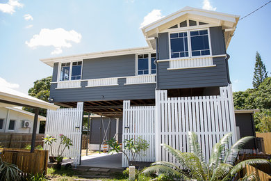 Photo of an eclectic two-storey grey house exterior in Townsville with a metal roof.