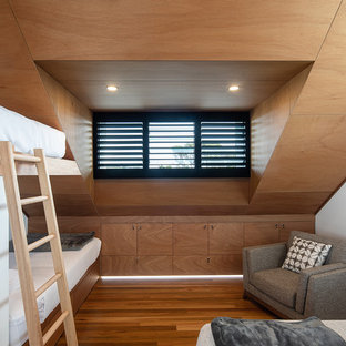 Photo of a beach style gender-neutral kids' bedroom in Gold Coast - Tweed with white walls, medium hardwood floors and brown floor.