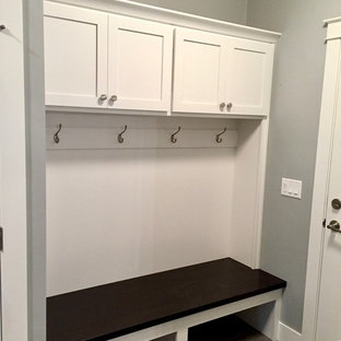 Photo of a mid-sized arts and crafts mudroom in Other with grey walls and vinyl floors.