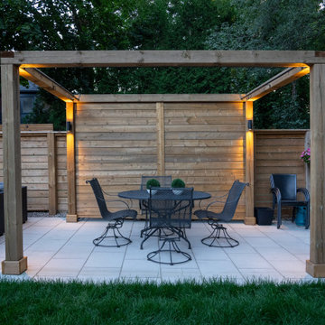 Modern Cedar Pergola, Porcelain Patio & Outdoor Lighting Backyard Renovation