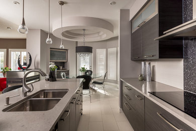 Open concept kitchen - large contemporary l-shaped porcelain tile and beige floor open concept kitchen idea in Toronto with a double-bowl sink, flat-panel cabinets, gray cabinets, quartzite countertops, beige backsplash and ceramic backsplash