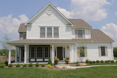 Example of a classic white two-story wood gable roof design in Cleveland
