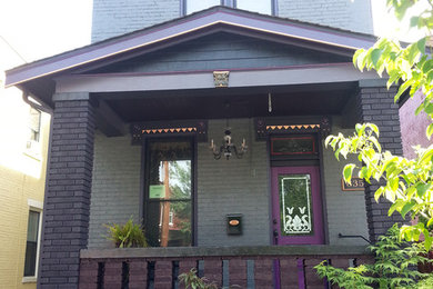 Inspiration for a mid-sized timeless gray two-story brick exterior home remodel in Cincinnati with a shingle roof