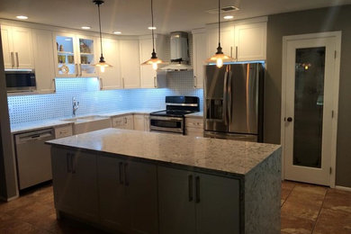 Open concept kitchen - mid-sized transitional u-shaped ceramic tile and beige floor open concept kitchen idea in Austin with a farmhouse sink, shaker cabinets, white cabinets, granite countertops, multicolored backsplash, porcelain backsplash, stainless steel appliances and an island