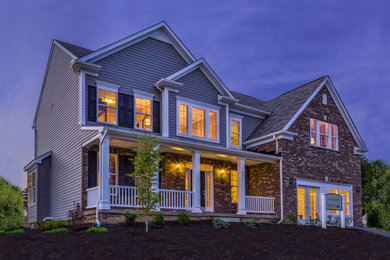 Large contemporary multicolored two-story vinyl exterior home idea in Other with a shingle roof