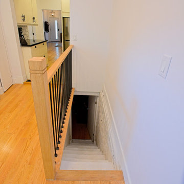 Oak and Black Metal Stair Guard Beside the Galley Kitchen | East York