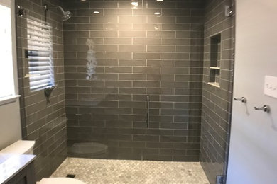 Design ideas for a small modern master bathroom in Dallas with shaker cabinets, grey cabinets, an alcove shower, a two-piece toilet, gray tile, ceramic tile, grey walls, marble floors, an undermount sink, quartzite benchtops, multi-coloured floor and a hinged shower door.