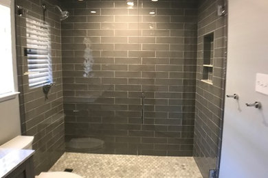 Inspiration for a small modern master gray tile and ceramic tile marble floor and multicolored floor alcove shower remodel in Dallas with shaker cabinets, gray cabinets, a two-piece toilet, gray walls, an undermount sink, quartzite countertops and a hinged shower door